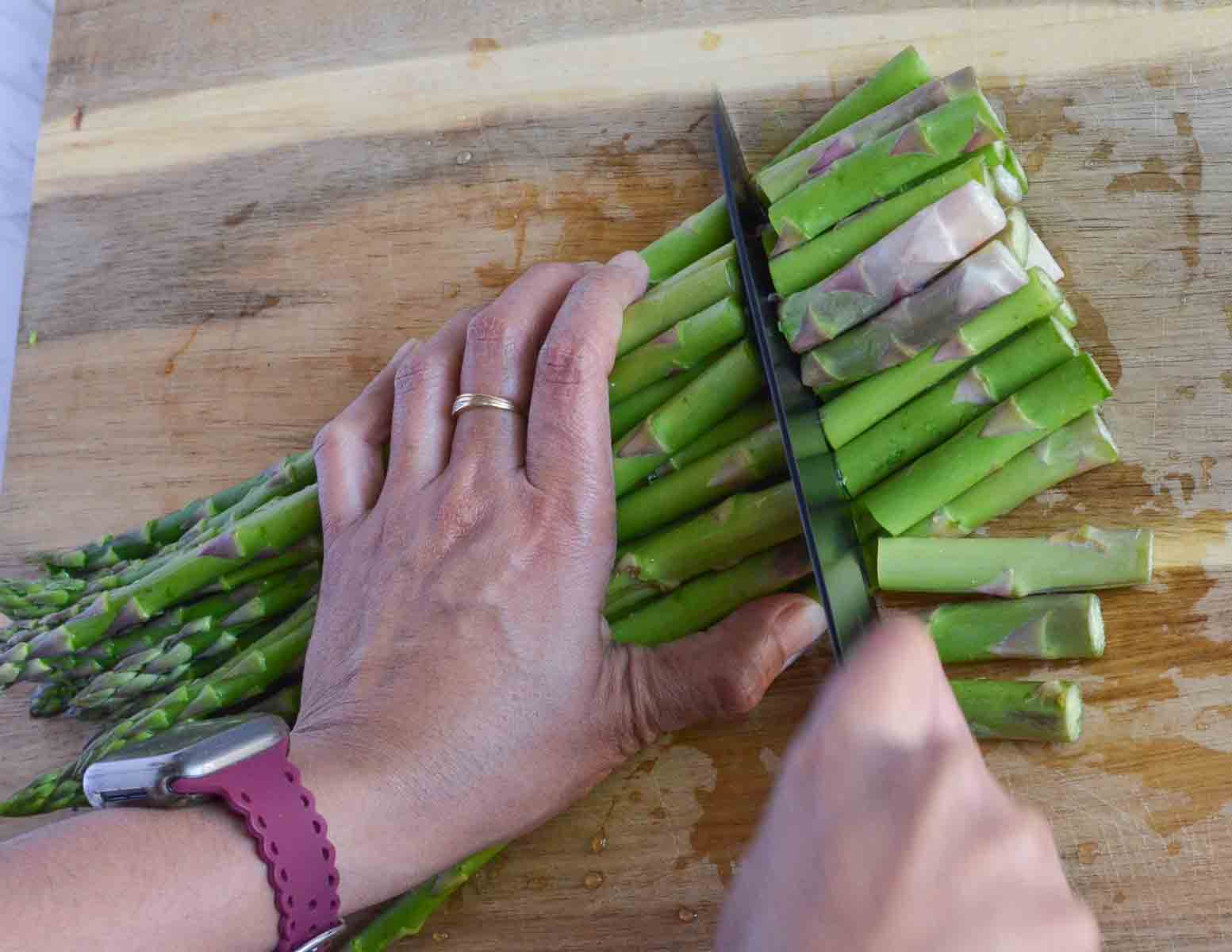 cutting asparagus to remove woody part