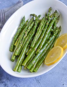 cooked asparagus seasoned with olive oil, garlic powder, kosher salt and lime juice