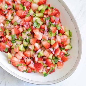 close up click of fresh strawberry salsa with cucumber