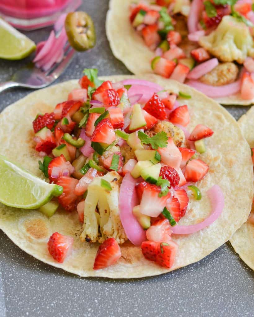 strawberry salsa served on tacos with lemon wedges