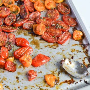 oven-roasted cherry tomatoes with balsamic vinegar in sheet pan