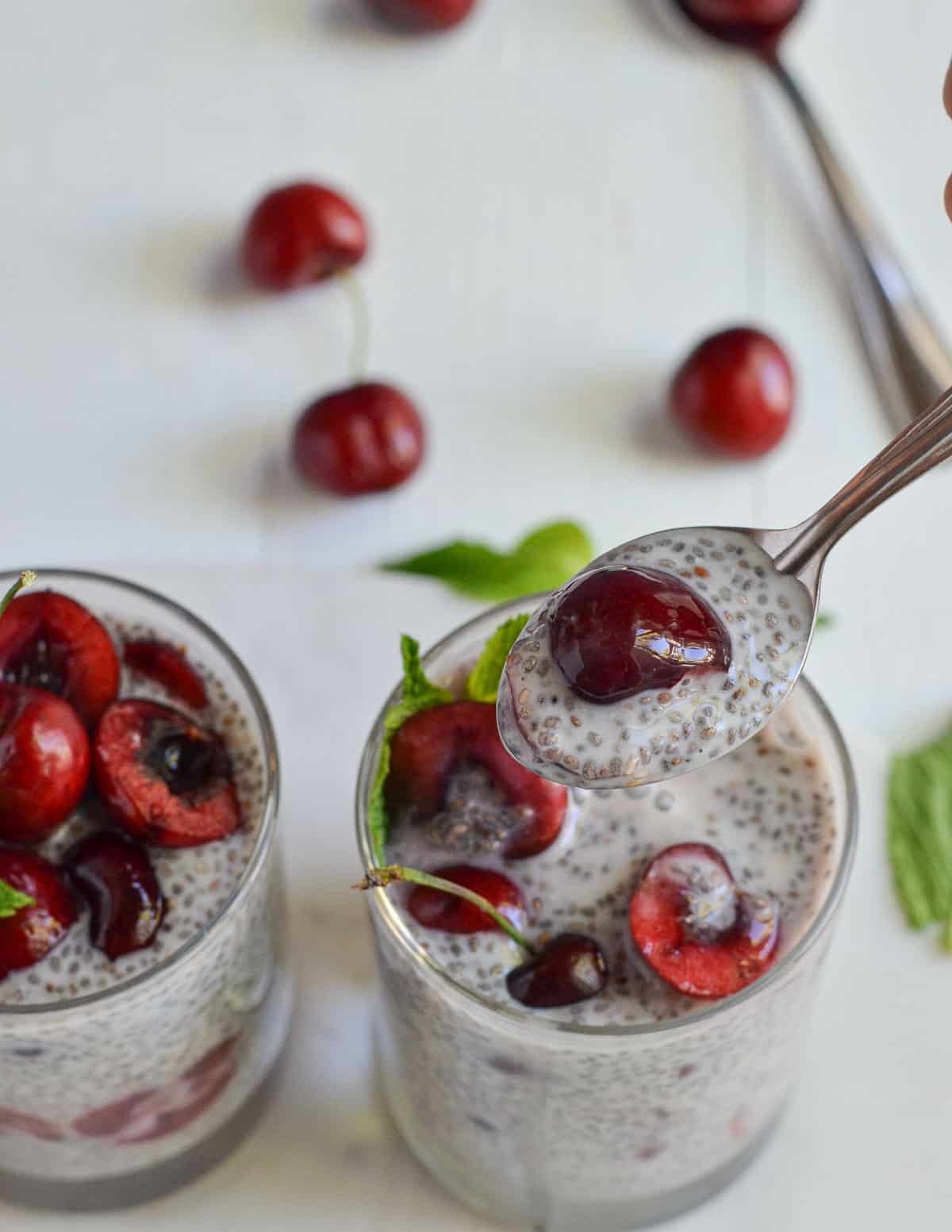 a spoonful cherry chia pudding shown in the click.