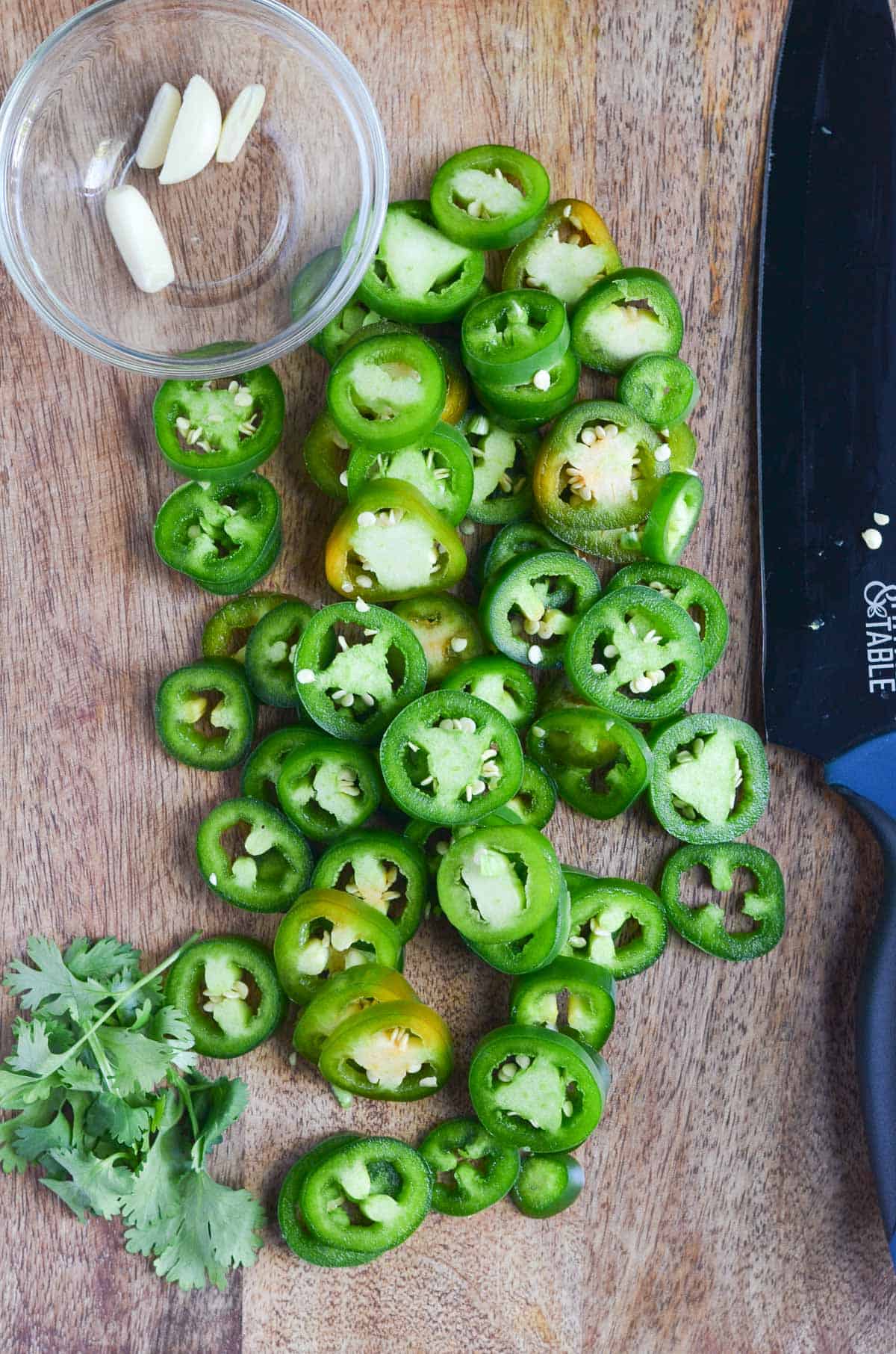 Thin jalapeno rings are cut, and sliced garlic pods.