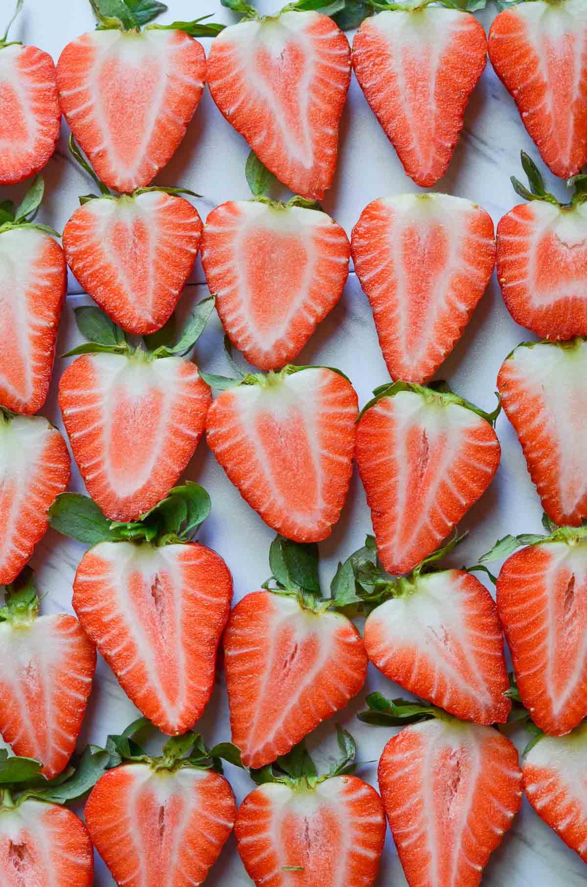 sliced strawberries kept on white board.