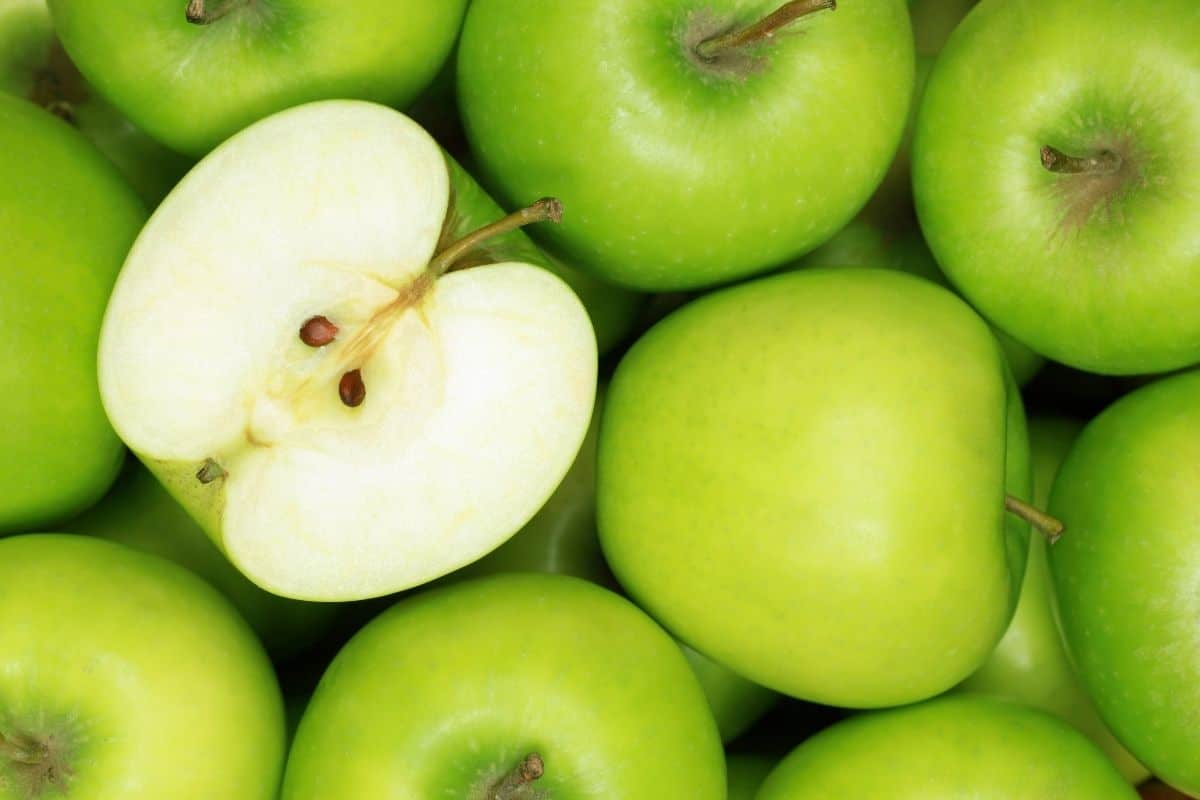 green apple image with half cut apple.